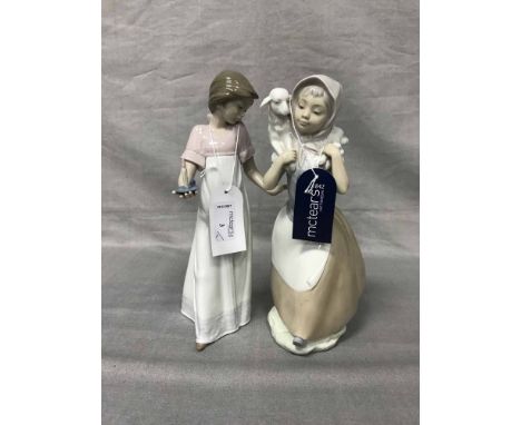 TWO NAO FIGURESone of a girl with a candle, the other of a girl carrying a lamb