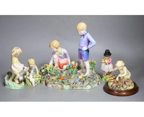 Four Royal Worcester figures of children by E.G. Doughty: 3150, 3076, 3103, 1416, and a larger Staffordshire table centre of 