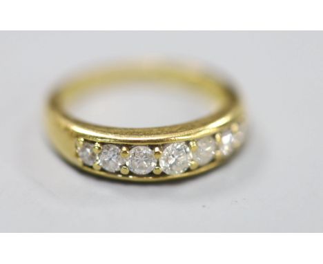 A modern 18ct gold and channel set seven stone diamond set half hoop ring, size K, gross 4.2 grams, total carat weight 0.50ct