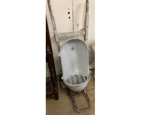 A vintage sack barrow together with a water fountain
