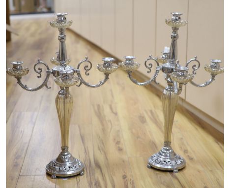 A pair of plated and glass four branch five light candelabra, height 68cm