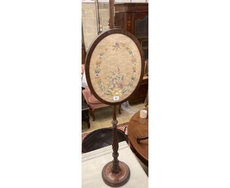 A Victorian mahogany pole screen, with oval tapestry banner, height 128cm