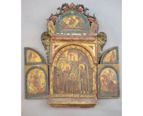 A 19th century Russian tempera on wood triptych icon, c.1800 with floral and bird carved crest, the central panel depicting t