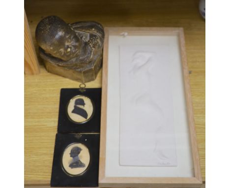 A pair of silhouettes, a plaster panel of a nude, indistinctly signed, and a plaster bust of a baby