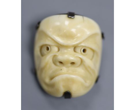 A 19th century Japanese carved ivory Noh mask netsuke mounted as a brooch, 4cm