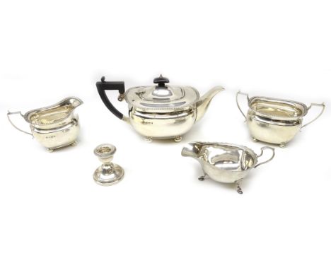Silver three piece tea set by Elkington Birmingham 1938, a sauce boat approx 35oz gross and a weighted candlestick Condition 