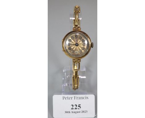 18ct gold ladies cushion shaped wristwatch with engine turned Arabic face and 18ct gold expanding bracelet.  Total weight 17g