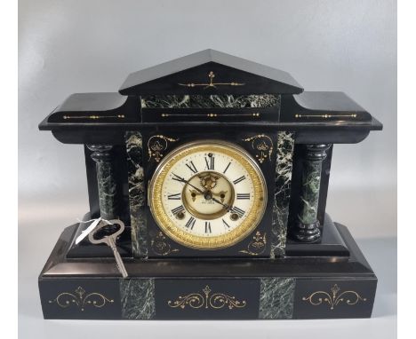 Early 20th century black slate and marble two train architectural; mantle clock with ceramic Roman face having exposed escape