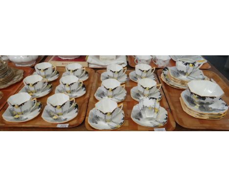 Three trays of Shelley English bone china 'Sunrise and Tall Tree' design tea ware to include: twelve cups and saucers, twelve