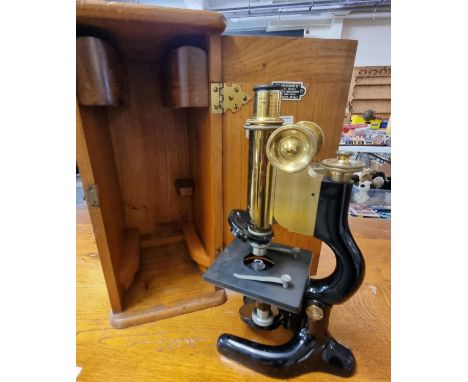 Lacquered brass and enamelled monocular microscope in original box with retailer's label 'Clarkson's of High Holborn, London'