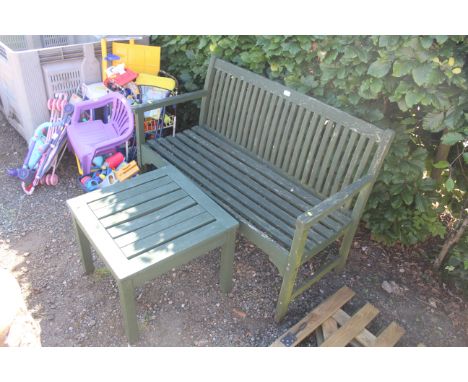 A green painted two seater garden bench and similar garden table 