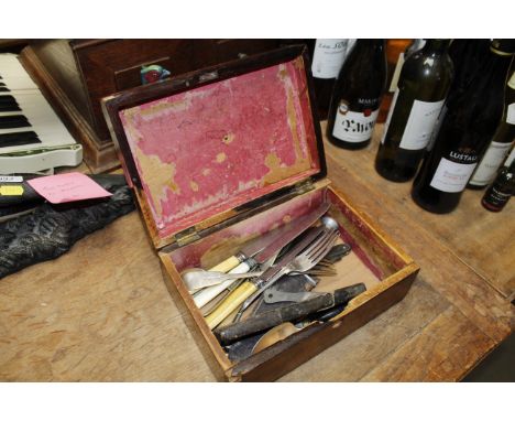 A George III silver spoon, various other cutlery, sheath knife, cut throat razor etc. contained in a rosewood box