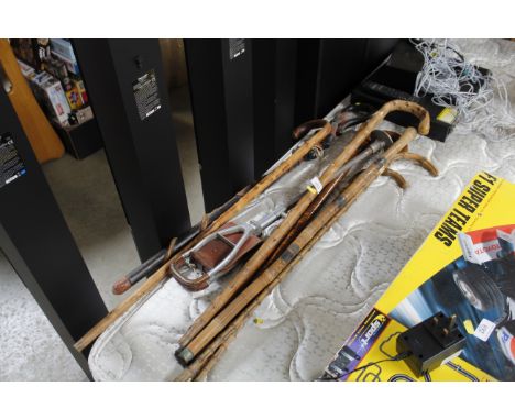 A quantity of various decorative walking sticks, a shooting stick etc
