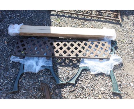 A pair of cast iron bench ends, a metal lattice effect backrest and set of wooden slats 