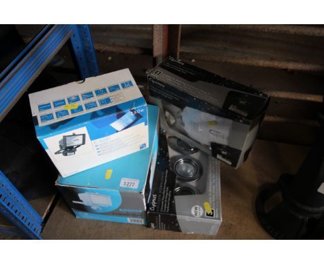 A Focus exterior flood light; a 150w security flood light; a box of Equinox 5 halogen downlights; and a box of Cygnus 3 halog