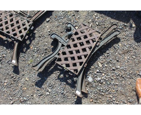 A pair of single seat cast iron bench ends and metal lattice effect backrest