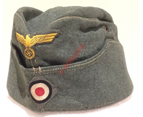 German Third Reich Army M38 feldmutze (field service cap) A good field grey woollen example bearing yellow BeVo eagle and swa