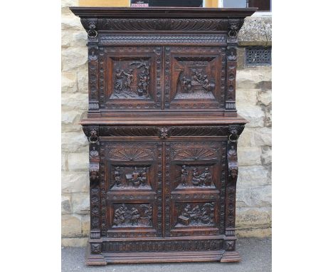 A Heavy Jacobean-Style Oak Court Cupboard; the cupboard having two splendidly carved cupboard doors above, with four interior