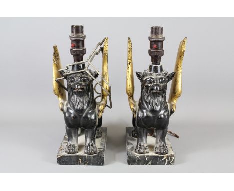 A Pair of Early 20th Century Carved Griffin Lamp Bases. The finely carved griffins are depicted seated with outstretched wing