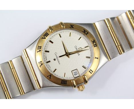 A Gentleman's Omega Constellation Gent's Watch; the gold and steel watch with white enamel face with baton dial, date apertur