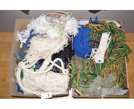 Assorted cotton and wool tie-backs and edging in two boxes. 