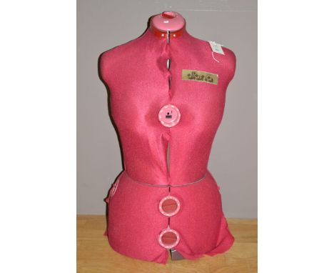 A Diana auto-set mannequin upholstered in pink material.