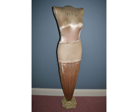 An Art Deco "Fitu" female mannequin upholstered in silk, raised on painted wood square quatreform base, 135cms high.
