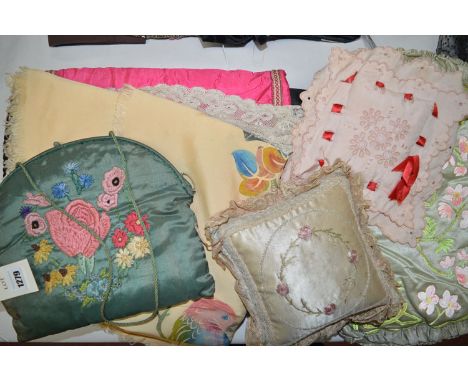 An early 20th Century silk tea cosy, applied floral decoration; a woolwork purse; two pin cushions; a silk table runner with 