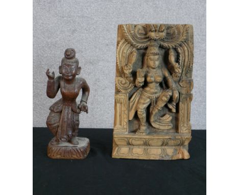 A 20th century Indian hardwood panel carved with a godess together with a carved Balinese hardwood figure of a male dancer ra