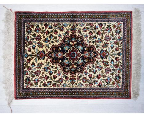 A Persian/Iranian silk Qum (Qom) rug, the central blue lobed panel in ivory field with stylised floral border. L.74 W.54cm 