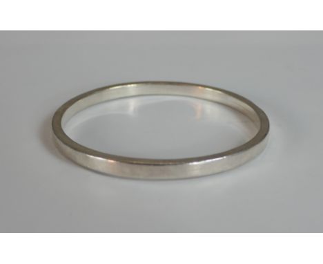 A boxed white metal (tests as silver) bangle. H.6 W.9 D.9cm 