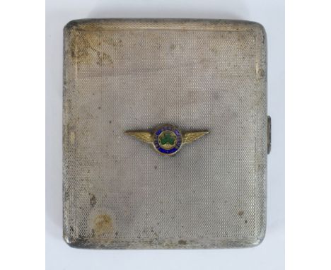 A George V hallmarked silver cigarette case, all over engine turned decoration, with applied enamel Irish Aero badge, opening