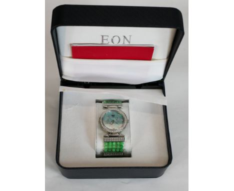 A new in box Eon fashion watch with Jade bead elastic bracelet and blue mother of pearl face. Box and papers. H.8 W.14 D.12cm