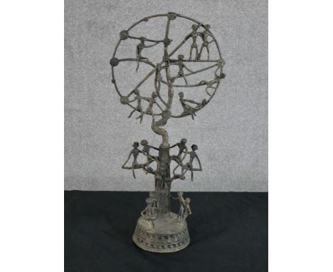 A late 19th/early 20th century African bronze Tree of Life sculpture raised on circular base. H.43 W.21 D.11cm 