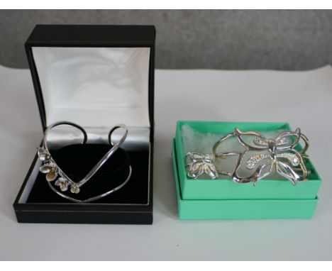 Two silver bangles and a ring. One bangle in the form of a butterfly with cubic zirconia studded wings with matching ring. Th