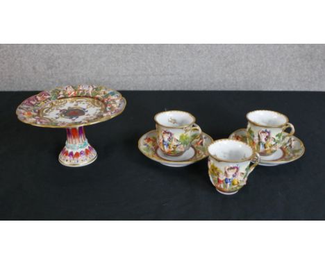 Six pieces of 19th century Italian Capodimonte comprised three cups, two saucers and a crested tazza, each piece moulded with