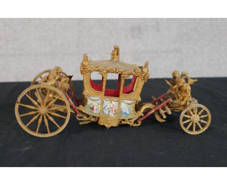 A 20th century scale model of the Coronation carriage, with hand painted decoration. H.9 W.22 D.10cm 