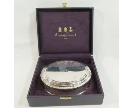 An Asprey and Co. oval silver trinket box, Birmingham 2001, the hallmarked hinged lid with stepped edge, engraved 'JJG' to th
