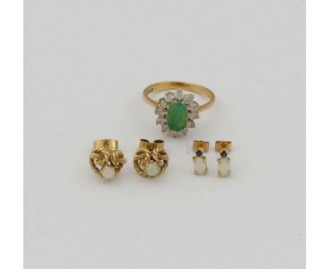 A 9 carat gold emerald and clear stone oval cluster ring, a pair of yellow metal sapphire and opal stud earrings and a pair o