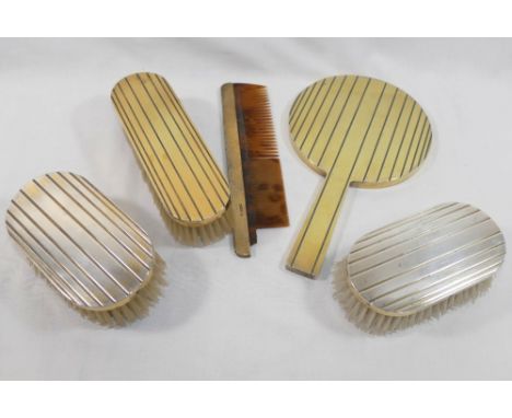 A Jacques Cartier three-piece&nbsp;silver gilt backed hand mirror, brush and comb set, London 1948 with graduated banding dec