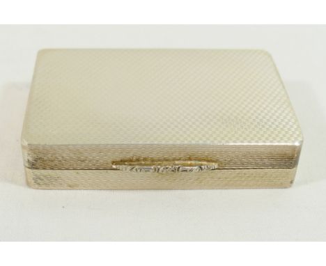 A rectangular silver snuff box with gilt interior, engine turned decoration and ornate cast thumb piece, Edinburgh 2000, with