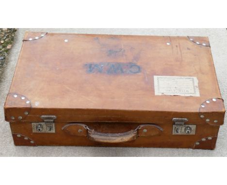A vintage leather suitcase, with chrome plated clasps and blue fabric lined interior, with accompanying leather straps, 60.5c