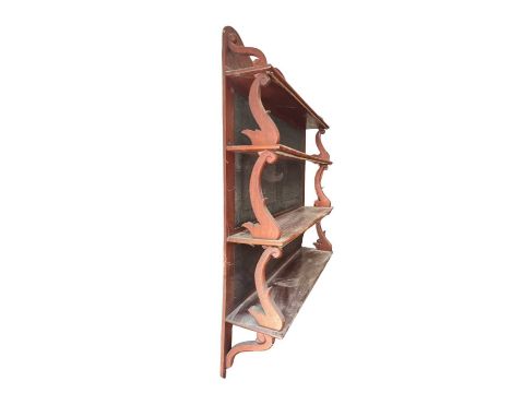 A Victorian waterfall hanging book shelf in mahogany with scrolling brackets and black fabric panels 91cm wide 109cm high and