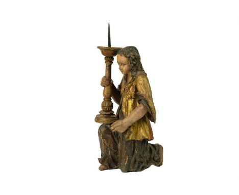 A painted and gilt altar pricket candlestick. 17th/18th century, probably Italian, carved as a kneeling angel, the candle hol