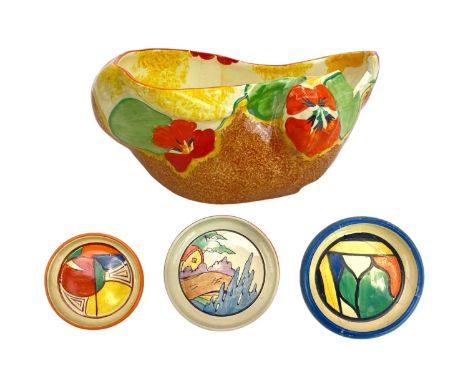 A Clarice Cliff Melon pattern pin tray. Fantasque Wilkinson Ltd marks, diameter 8cm together with an Orange Roof Cottage pin 