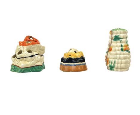 A Clarice Cliff banded flower block/frog. Height 9cm together with a smaller flower block /frog, and a Raffia sugar sifter. (