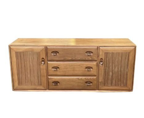 An Ercol light elm Windsor sideboard. Fitted with three central drawers and two cupboards, height 62cm, width 156cm, depth 44