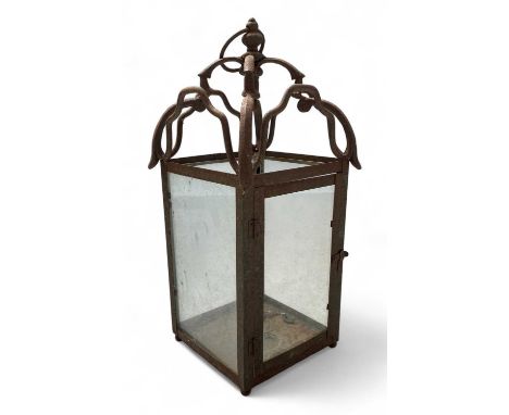 An iron framed outdoor hanging lantern With four glass panels, height 47cm.
