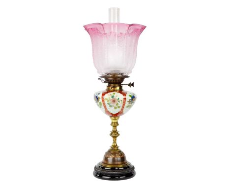 A late Victorian oil lamp with large cranberry etched shade. Stamped Young's, height 63.5cm.A