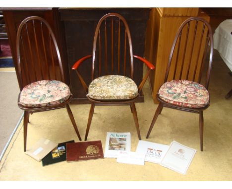 Three Ercol stick back chairs, one armchair with original paperwork. 